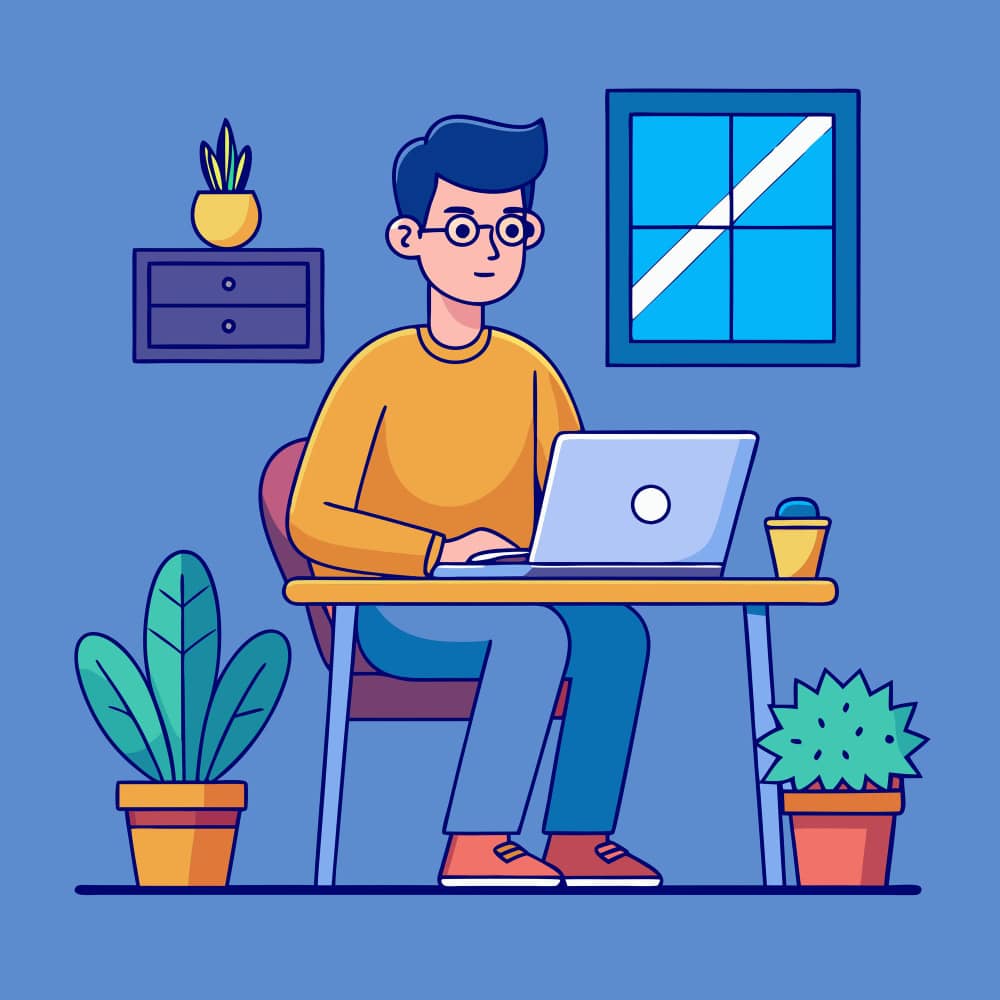 شاب يجلس على مكتب وينظر إلى لاب توب