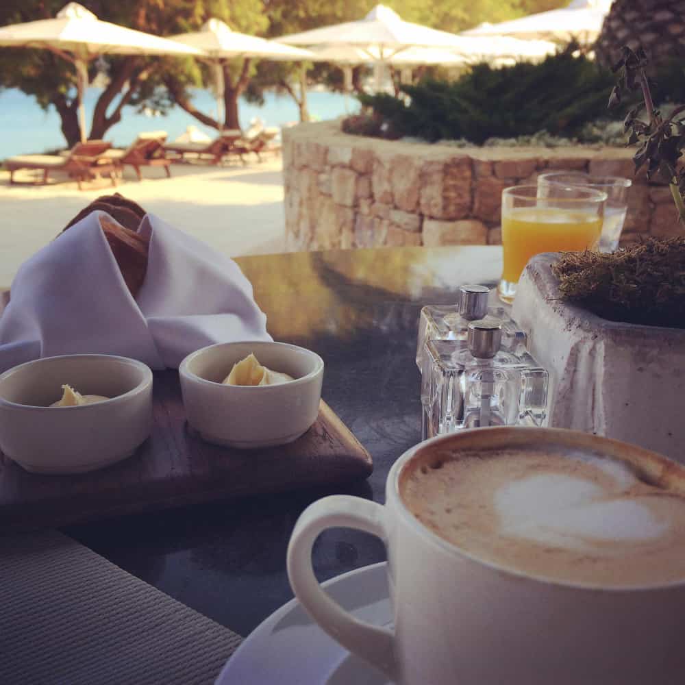 كوب قهوة على منضدة بجانب البحر